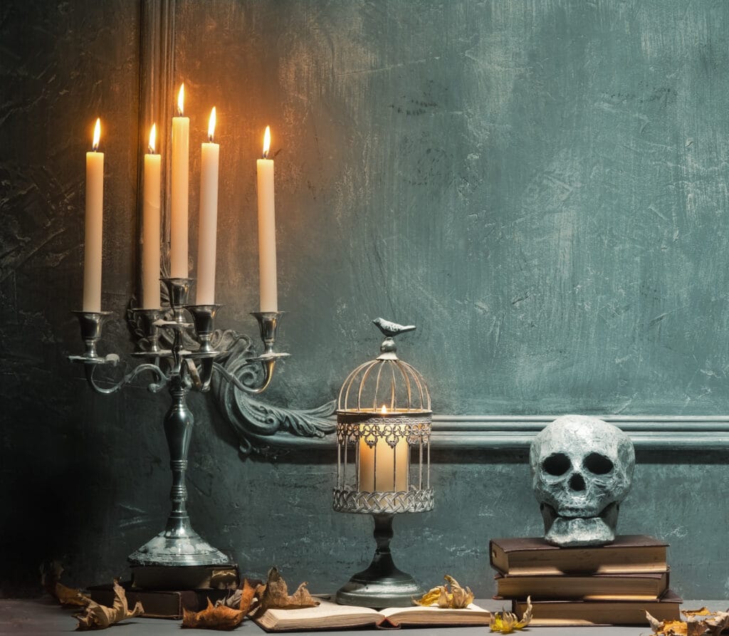 Scary laughing pumpkin and old skull on ancient gothic fireplace. Halloween, witchcraft and magic concept.