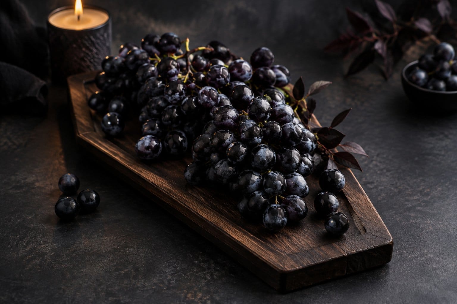 Black grapes arranged on a coffin-shaped serving board.