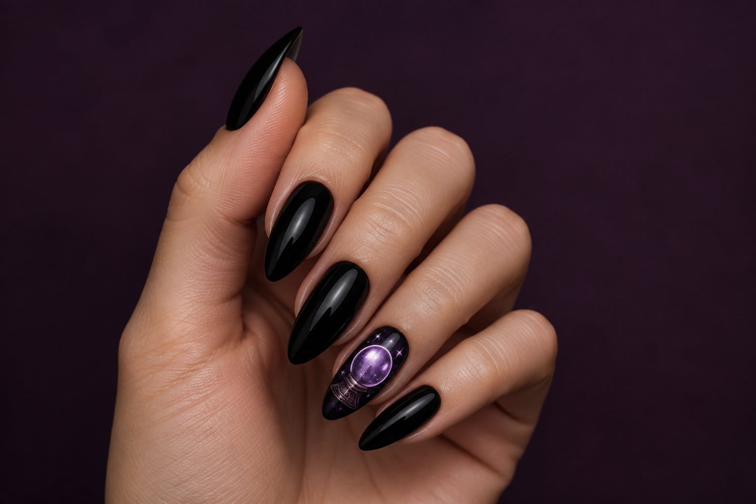 A hand with glossy black nails and a purple crystal ball accent nail.