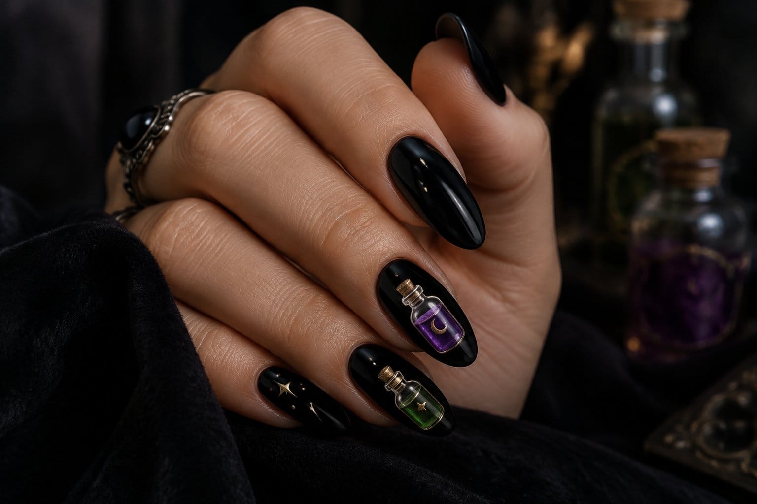 A hand with glossy black nails decorated with tiny potion bottle designs.